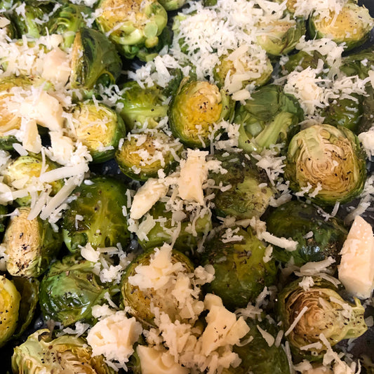 roasted brussels sprouts with shredded asiago cheese on top